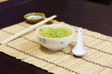 White bowl of cream asparagus soup