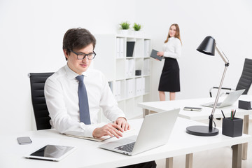 Businessman and businesswoman in office