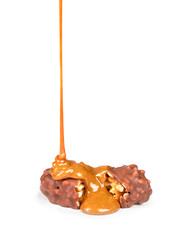 sweet caramel sauce is poured on a chocolate bar