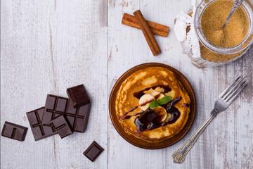 Delicious pancakes with bananas and chocolate.