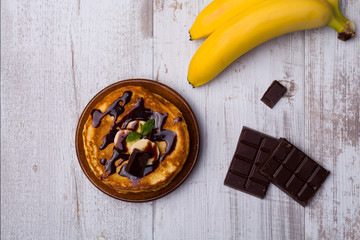 Delicious pancakes with bananas and chocolate.