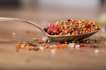 Spoon with spices on the table, close-up