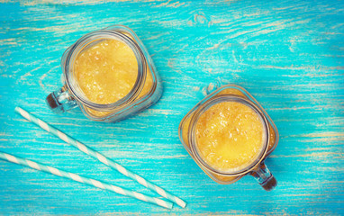 yellow fruit smoothies in mason jars
