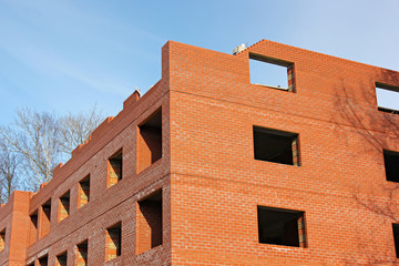 The construction of a new house of red brick