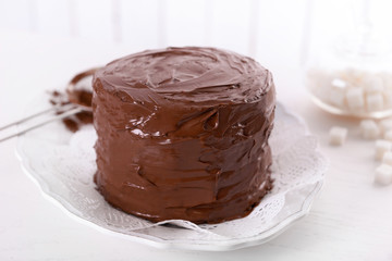 Tasty chocolate cake on light background