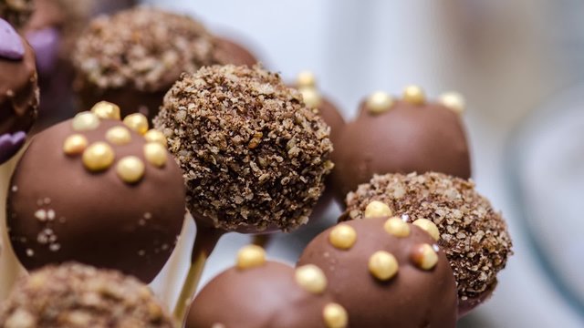 Chocolate marshmallows on sticks of wood at wedding reception