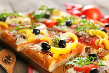 Pieces of delicious pizza on the table, close-up
