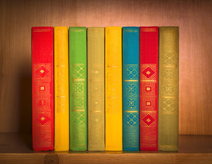 books on shelf, close-up, on wooden background
