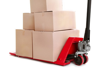 Fork pallet truck with stack of cardboard boxes isolated on white