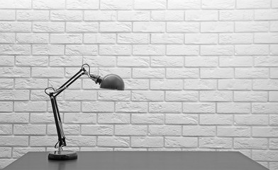 Modern lamp on the desk on white wall background