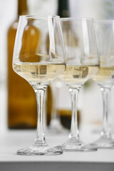 Glasses of white wine on table closeup
