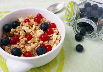 Healthy breakfast muesli with blueberry and red currant and milk with blueberry and raspberry