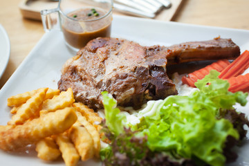 pork chop with gravy sauce,french friesand vegetable