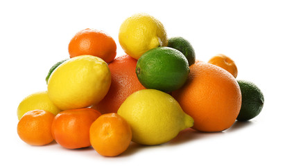 A heap of mixed citrus fruit including   lemons, limes, grapefruit, oranges and tangerines isolated on a white background, close up