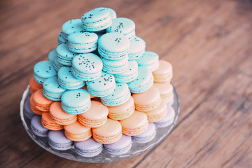 Many varicolored tasty macaroons on a dish