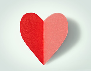 Red paper heart isolated on white background, close up