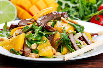 Fresh Tasty Mango, beef salad with vegetables and nuts.
