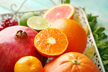 Juicy composition of tropical fruits on a tray, close up