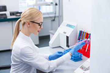 Beautiful female researcher is working in laboratory