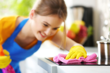Cleaning concept. Woman washes an oven, close up