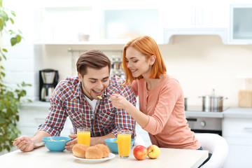 Obraz na płótnie Canvas Young beautiful couple have healthy breakfast