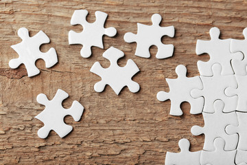 Incomplete puzzles on wooden table