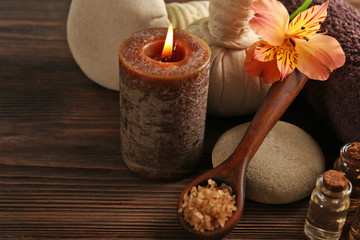 Spa set with sea salt, exotic flowers, candle, massage balls and towel, close up