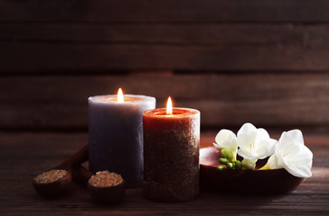 Fototapeta na wymiar Spa composition with alight candles on wooden background