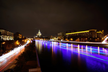Fototapeta na wymiar Moscow Kotelnicheskaya Embankment Building and ships on Moskva river at night. Time-lapse. September 17, 2014