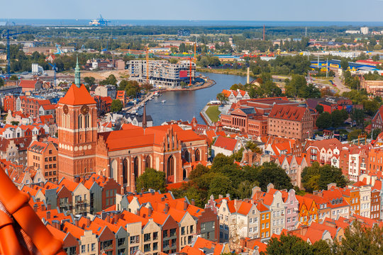 Aerial view of Old Town with St. John church and Motlawa River, harbor, ship yard and Baltic Sea in the summer morning, Gdansk, Poland