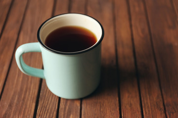 Mug of tea on wooden background