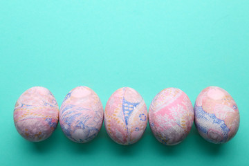 Easter eggs in a row, top view