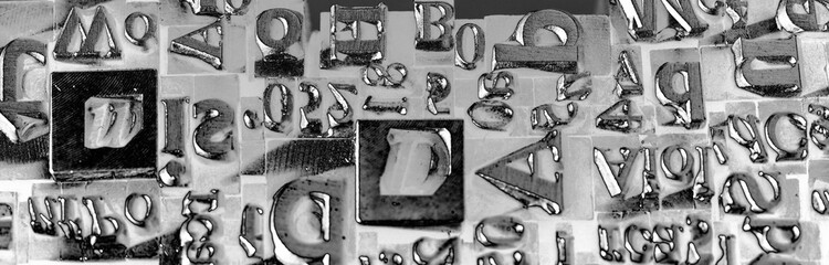Metal Letterpress Types.
A background from many historic typographical letters in black and white with white background.