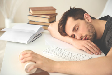 Young man fell asleep during reading.
