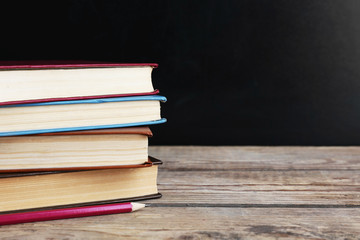 Few books with pencil on table