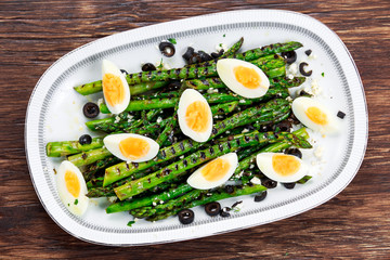 Grilled asparagus salad with feta cheese, olives and eggs