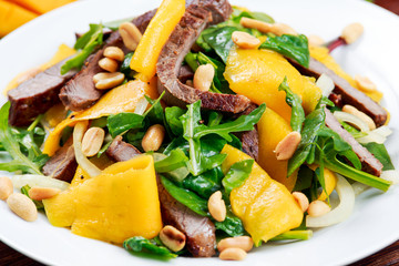 Fresh Tasty Mango, beef salad with vegetables and nuts.