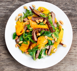 Fresh Tasty Mango, beef salad with vegetables and nuts.