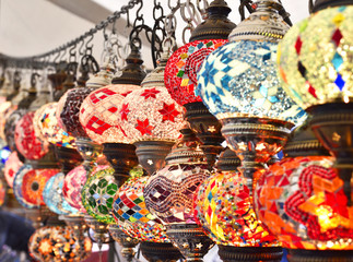 Turkish or oriental lamps on a bazaar with selective focus on the foreground. Multicolored lamps or...