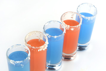 Beautiful row line of different colored alcohol cocktails
