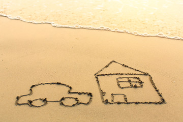 House and a car drawn on the sea beach.