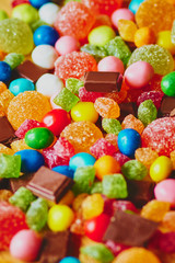 Fototapeta na wymiar Colorful candies and chocolate background