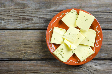 Shredded cheese on a clay plate
