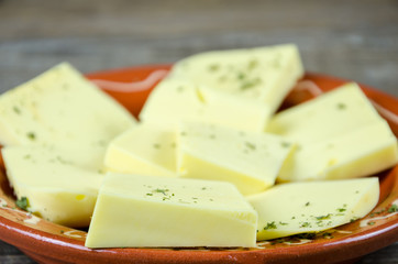 Shredded cheese on a clay plate