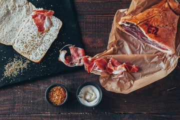cooking tasty panini with ham covered with cheese, tomatoes and flavoring