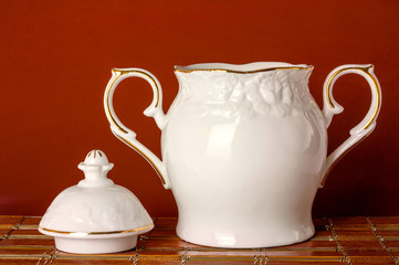 White sugar bowl on bamboo mats