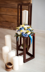 wedding bouquet with white and blue flowers with white candles