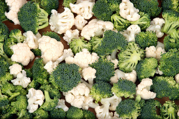 Organic cauliflower and broccoli on wooden plate
