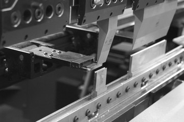Bending press that works a piece of sheet metal. - obrazy, fototapety, plakaty