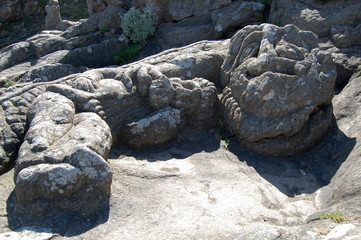 sculpture, carved out of the rock near the sea